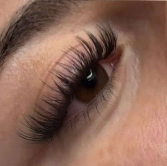 A long wispy set with spikes on a brown eye, close up